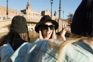 Cheerful women floating on river