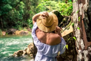 girl in hat at the river
