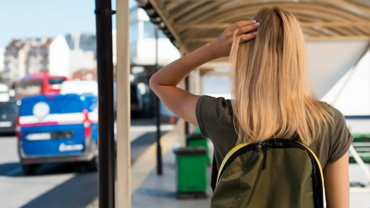 Mid shot woman with backpack in bus station